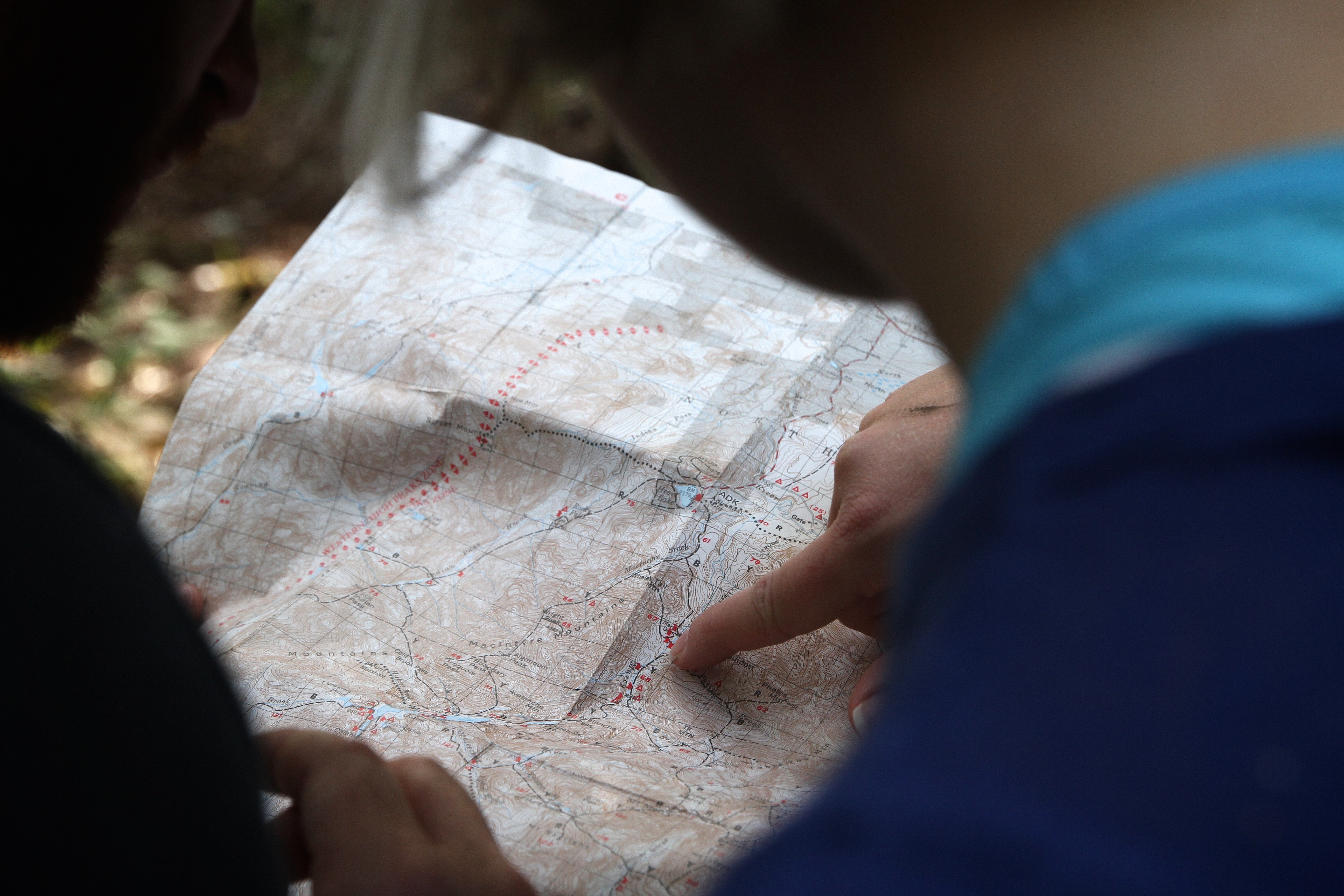 A person pointing to a map