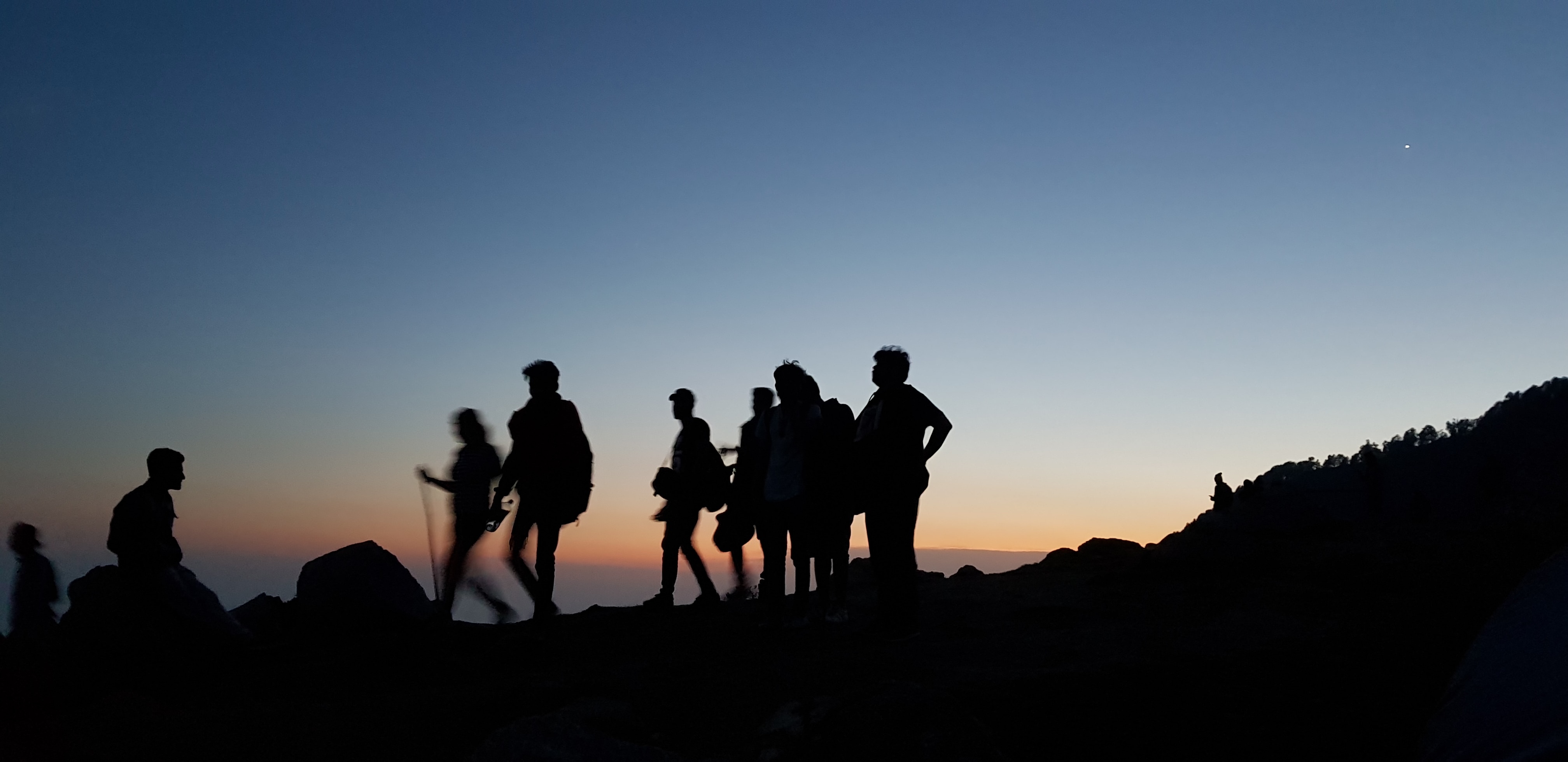 Group of people hiking at dawn
